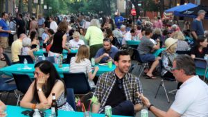 people sitting at tables and chairs