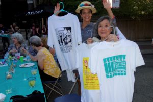 two women holding art fair t-shirts