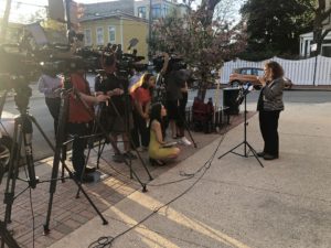 Video crew recording a woman