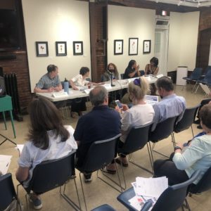 People sitting in chairs for a meeting