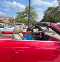 Dorothy DeCarlo in a red car