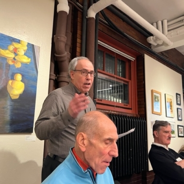 Picture of a man speaking in front of a crowd
